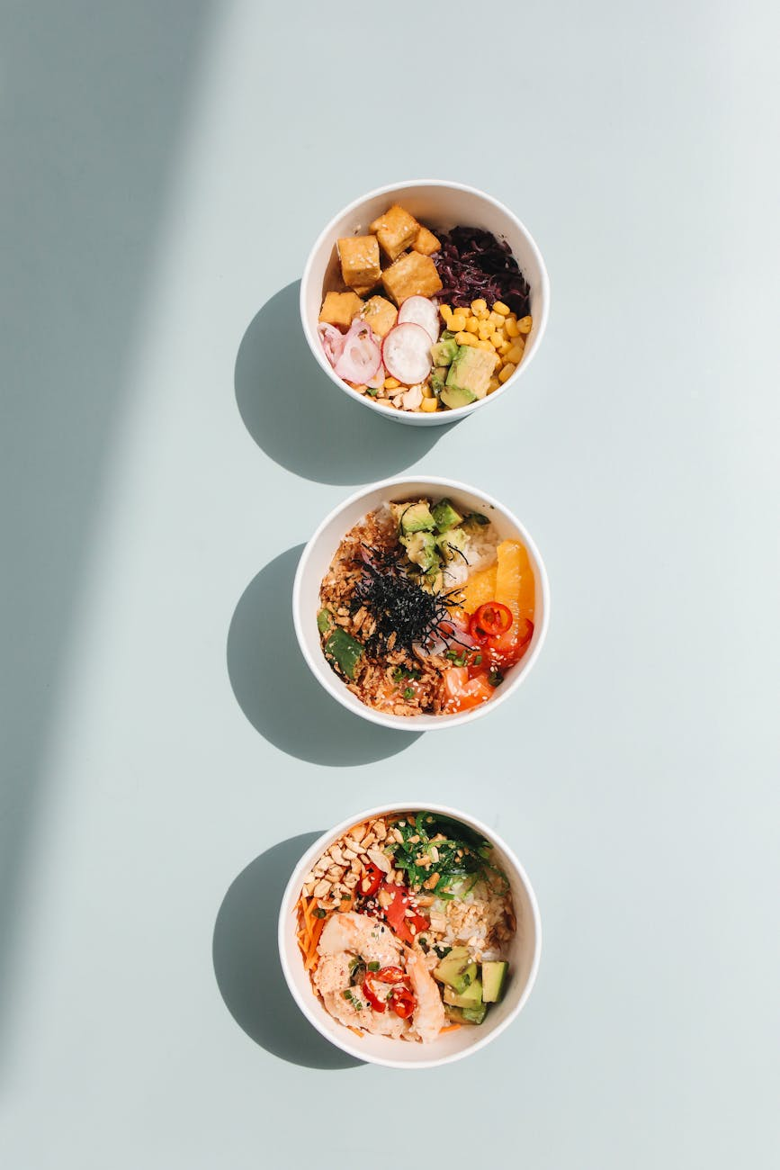 photograph of poke bowls on a blue surface